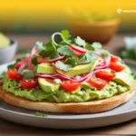 Tostada con Aguacate: rebanada de pan tostado cubierta con aguacate cremoso y tomate.