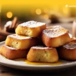 Deliciosas torrijas doradas espolvoreadas con canela y azúcar, servidas en un plato con frutas frescas.